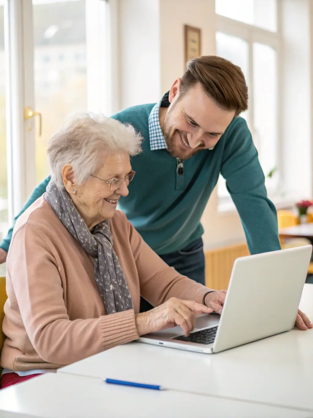 A group of seniors participating in a computer literacy class, learning how to use tablets and navigate the internet.
